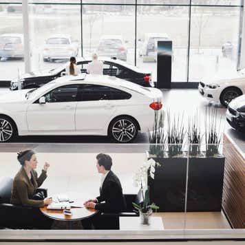 High angle view of saleswoman and customer discussing in meeting at showroom