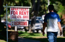 housing discrimination - man walking past "apartment for rent" sign