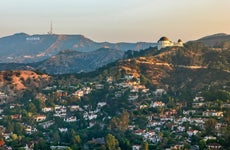 Aerial view of the Griffith Observatory on Mount Hollywood and the Hollywood Sign seen in the distance, California, USA.