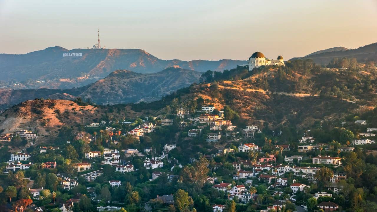 Aerial view of the Griffith Observatory on Mount Hollywood and the Hollywood Sign seen in the distance, California, USA.