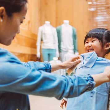 Woman shops for clothes with daughter