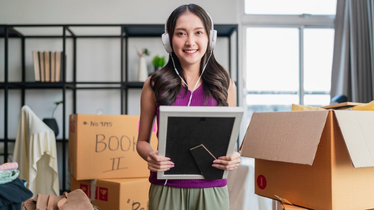 Adult asianwoman female in casual cloth standing on floor preparing for moving to new house