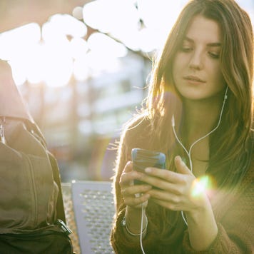 Young Backpacker With Smart Phone At Airport
