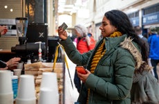 young woman paying for a coffee