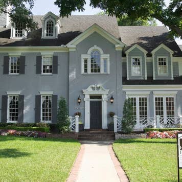 Exterior of house with for sale sign in front yard