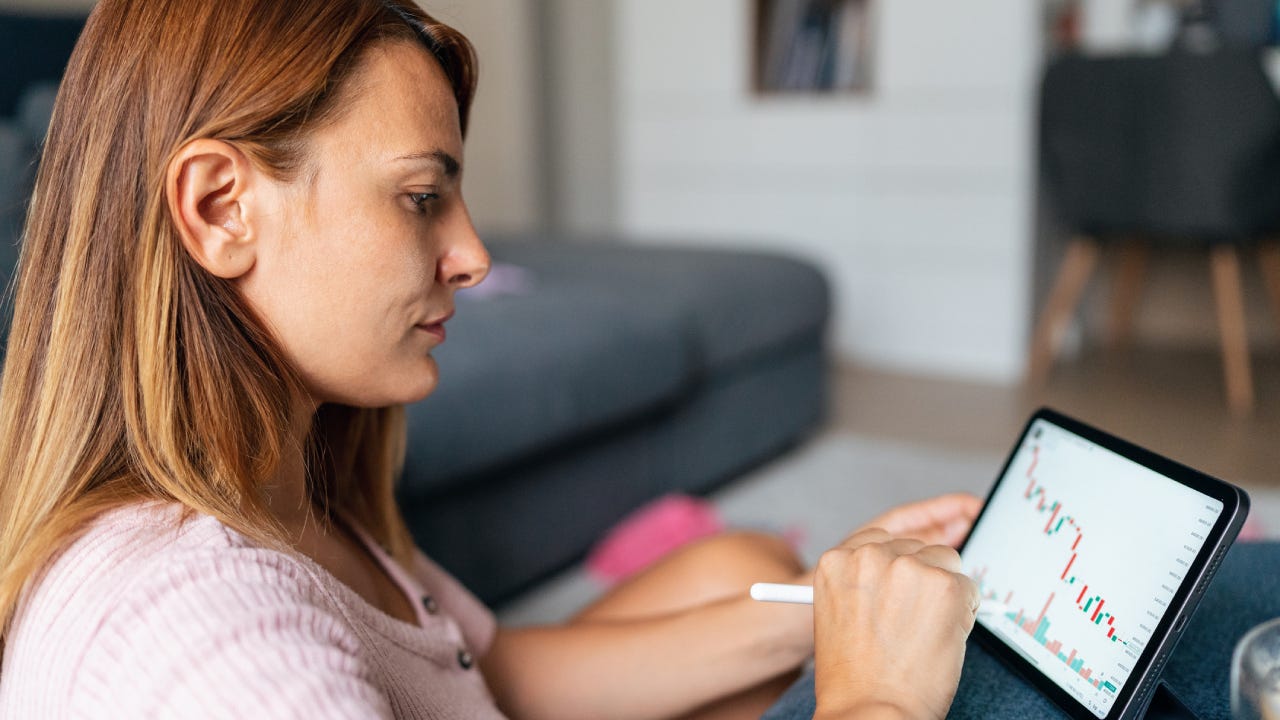 Woman at home office trading Online Using digital Tablet