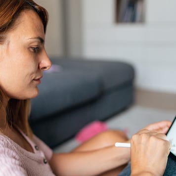 Woman at home office trading Online Using digital Tablet