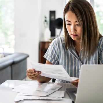 Woman paying bills at home