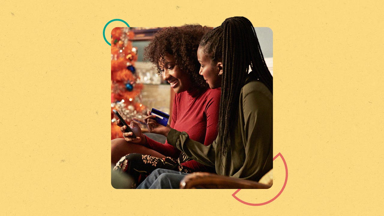 Two women paying for something with a credit card on their cell phone