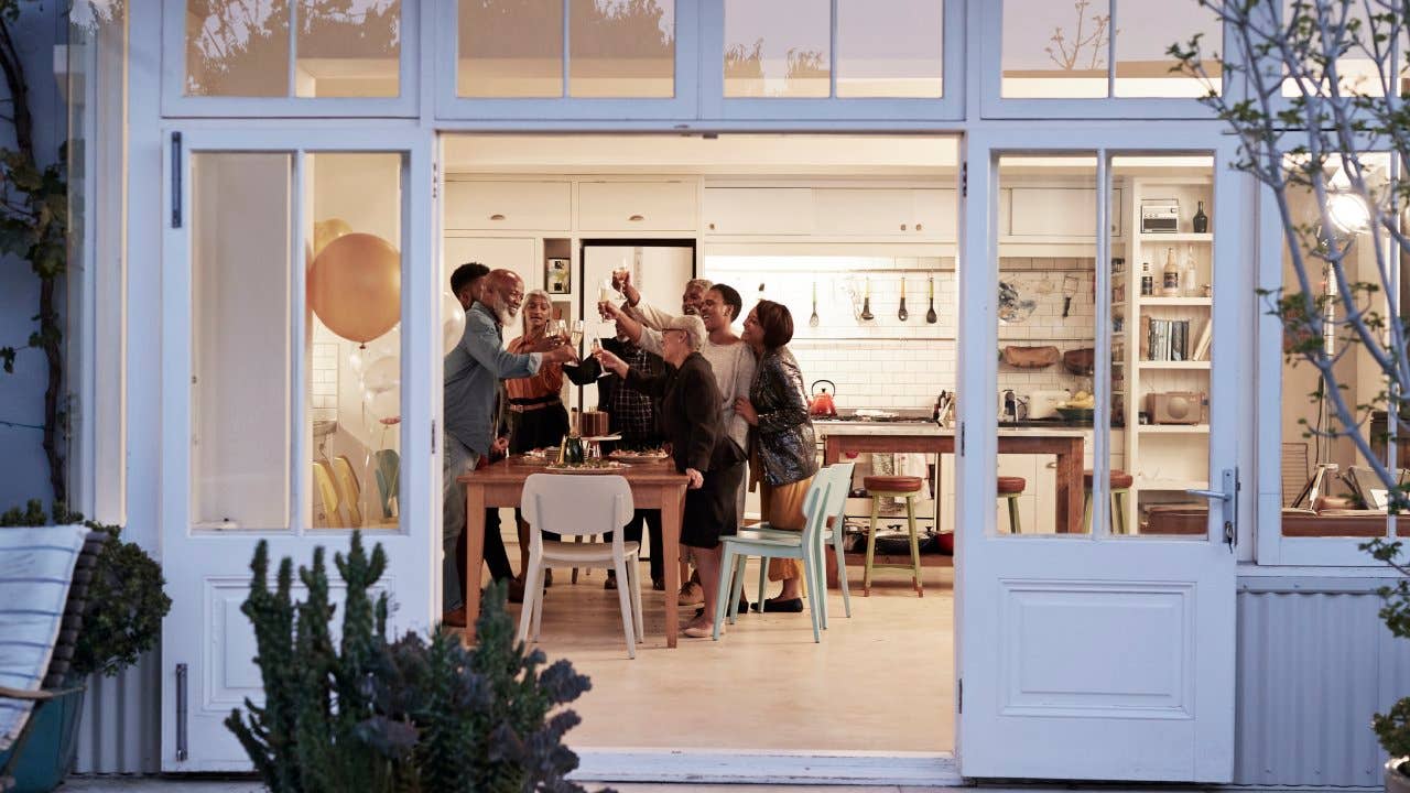 heerful family toasting drinks during a party