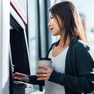 Woman getting money out of an ATM