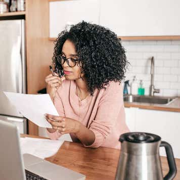 Woman planning expenses in the kitchen
