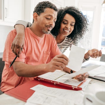 A happy couple looking over financial documents