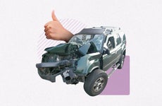Thumbs up coming out of a wrecked car