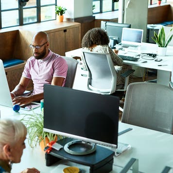 people working on computers in an office
