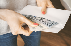 Woman holding envelope of cash