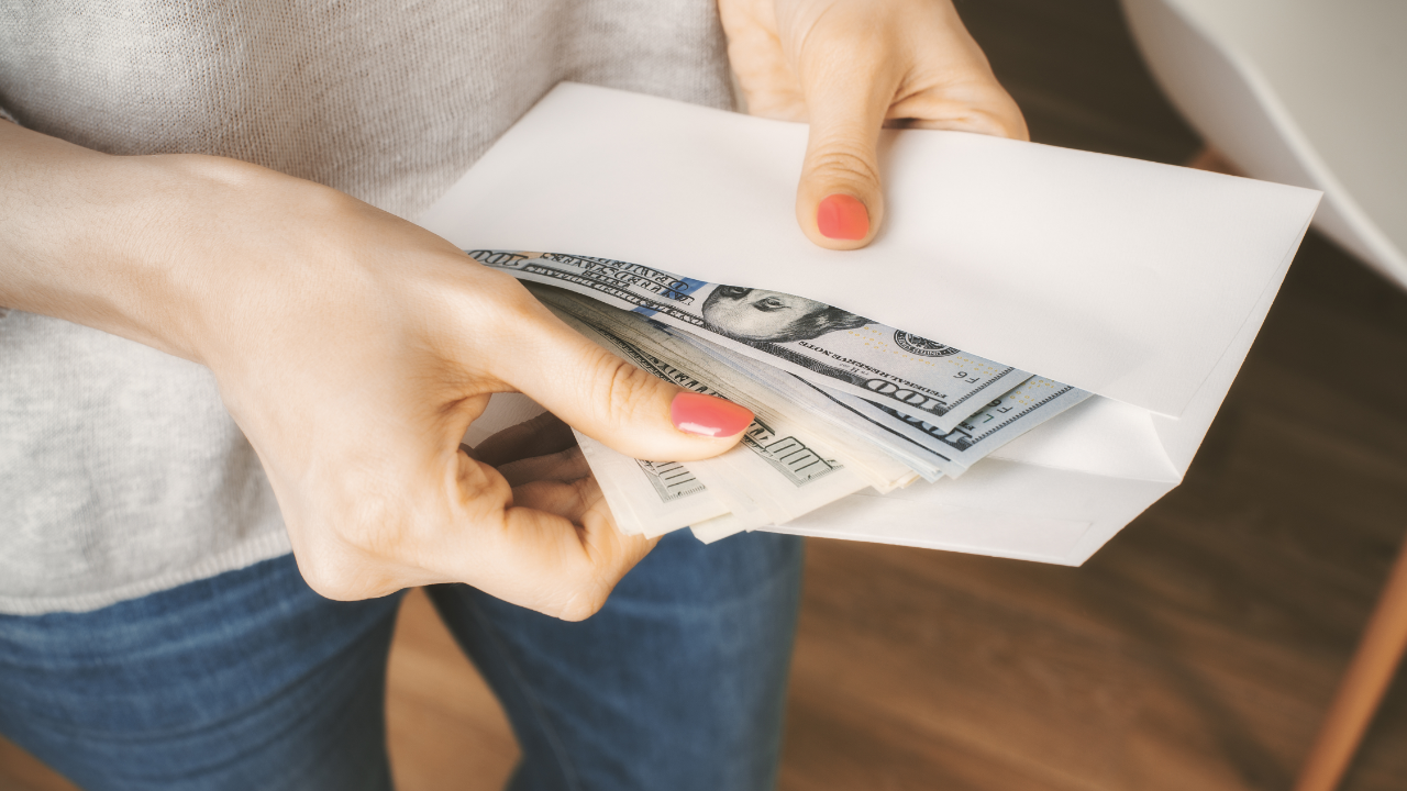 Woman holding envelope of cash