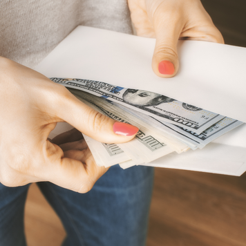 Woman holding envelope of cash