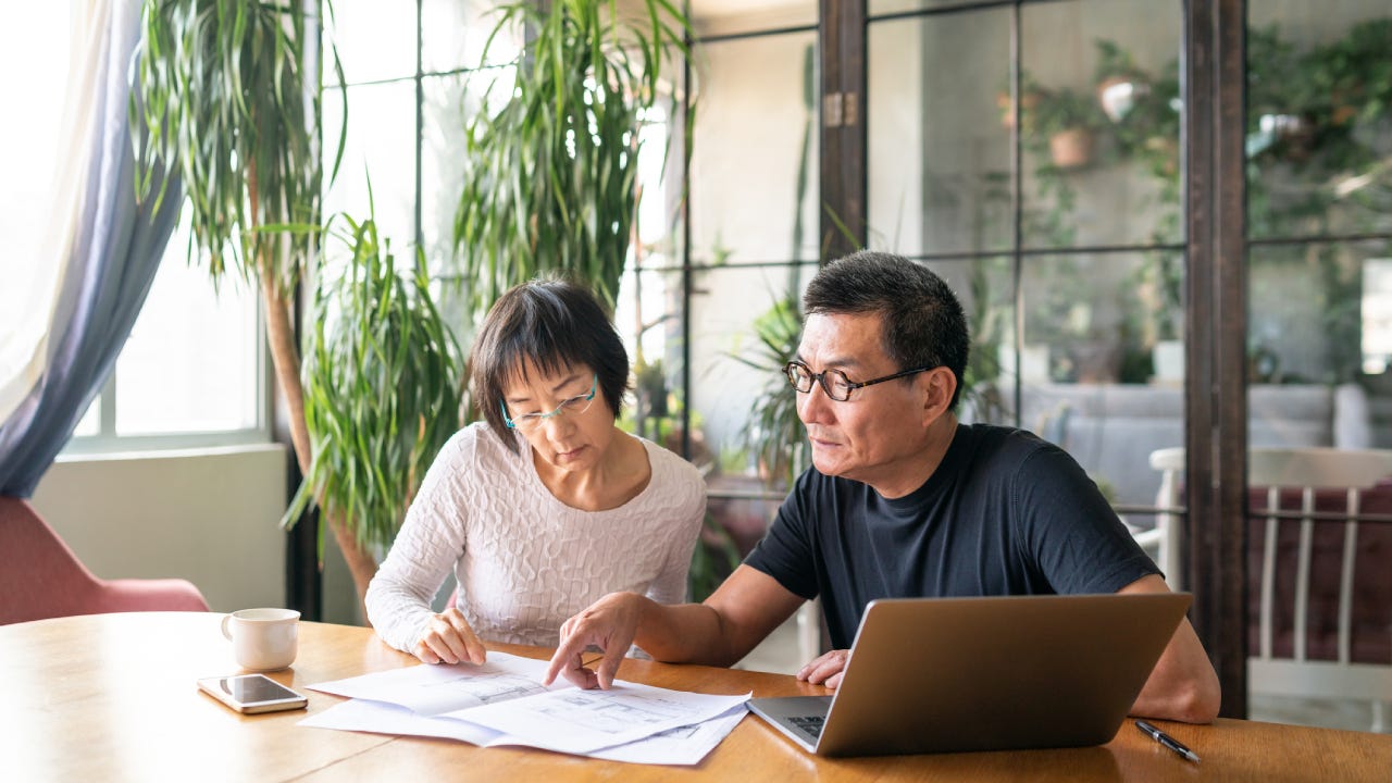 Mature couple working in a design studio