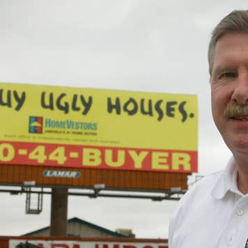 Paul Parker of HomeVestors by one of the many signs the company has put up in the Denver Metro area