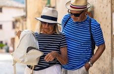 Senior tourist couple discovering missing wallet
