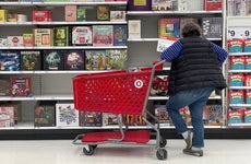 A woman shopping for a board game at Target