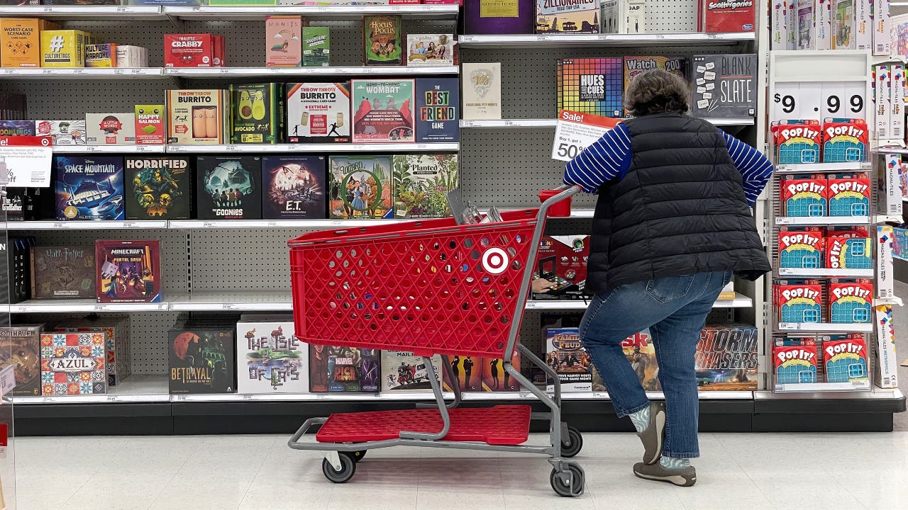 A woman shopping for a board game at Target