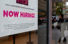 Now hiring sign in a shop window
