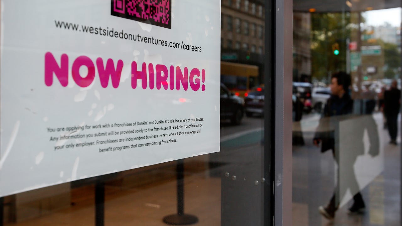 Now hiring sign in a shop window