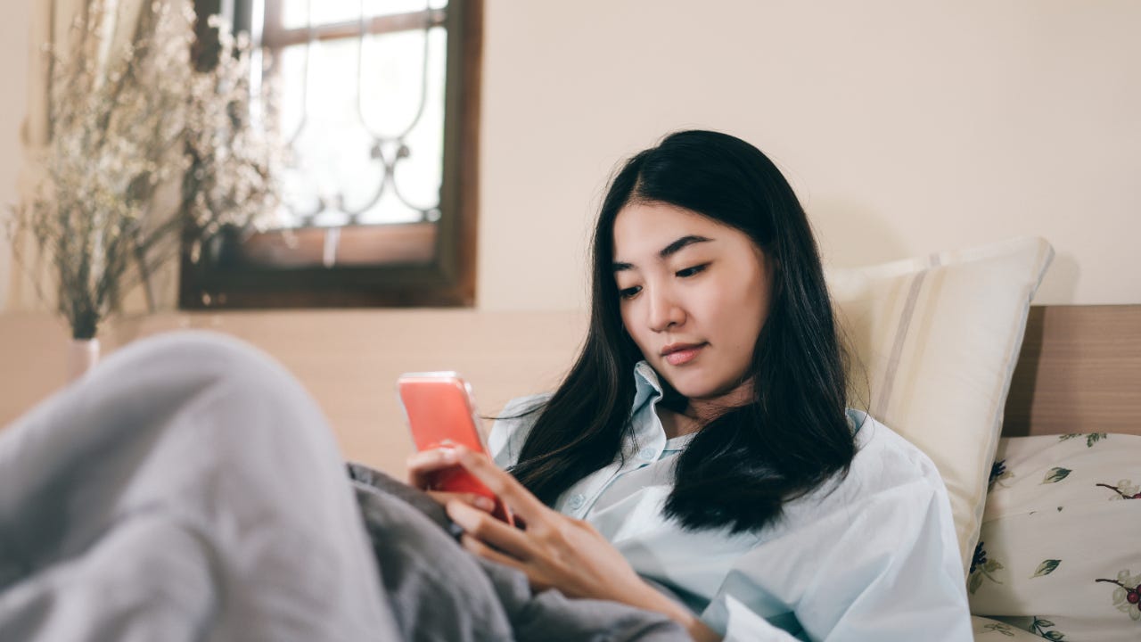 Person in bed on phone