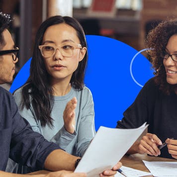 A couple going over tax documents with a professional.