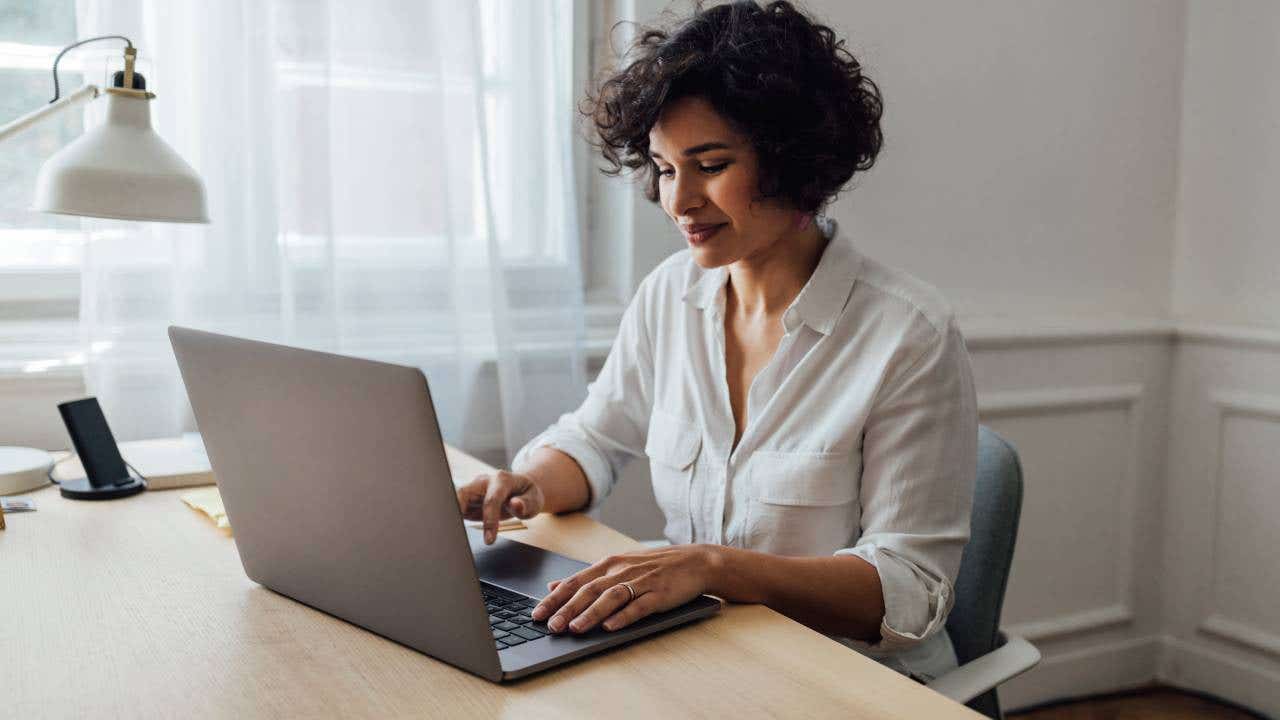 A mixed-race businesswoman typing on her computer.