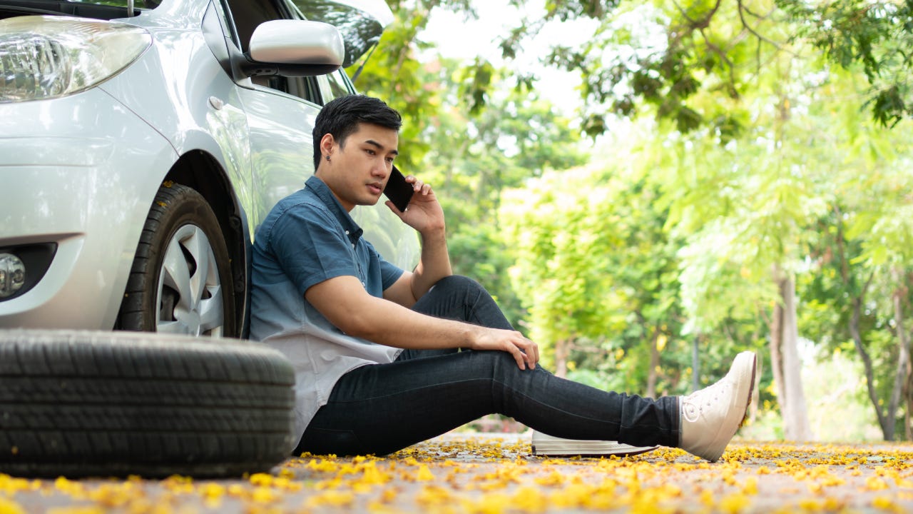 Full Length Of Young Man Sitting In Car - stock photo