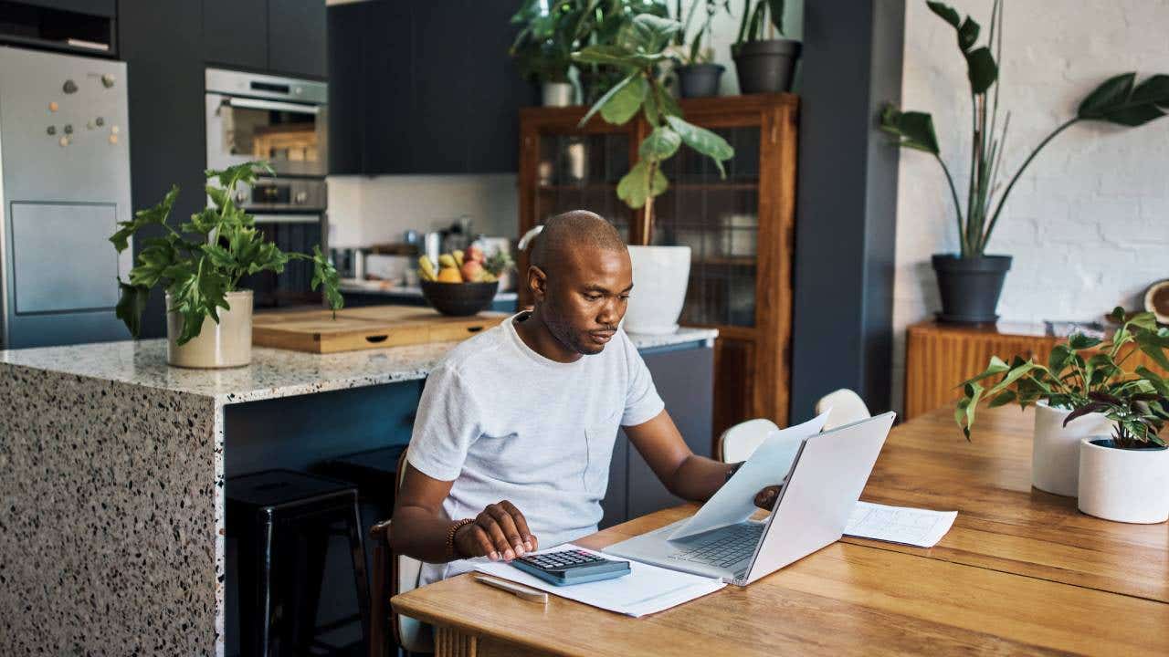 Black man remote work from home with finance analysis of bills or bank loan