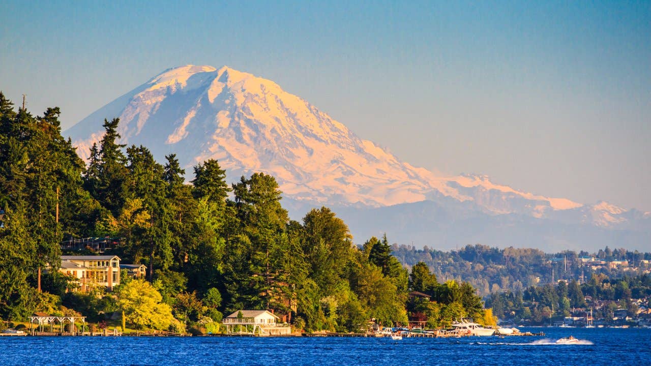 Mount Rainier bathed in sunset light, with Lake Washington in foreground.