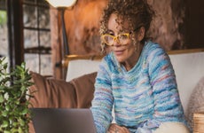 Smiling Woman Using Laptop At Home
