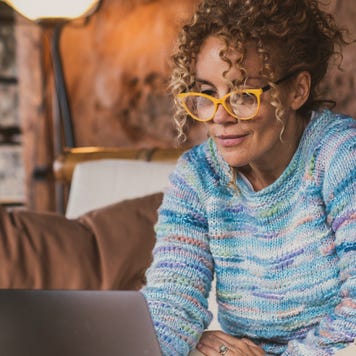 Smiling Woman Using Laptop At Home