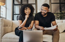Black couple, online banking and finance documents for bill payments at home.