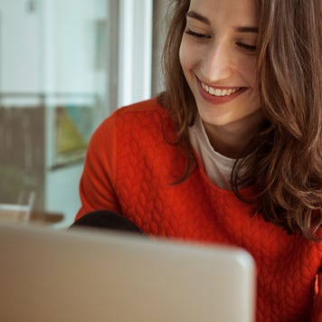 Smiling woman on laptop