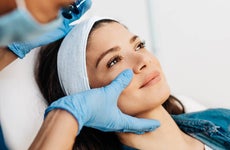 Young woman getting a rejuvenating facial injections at beauty clinic