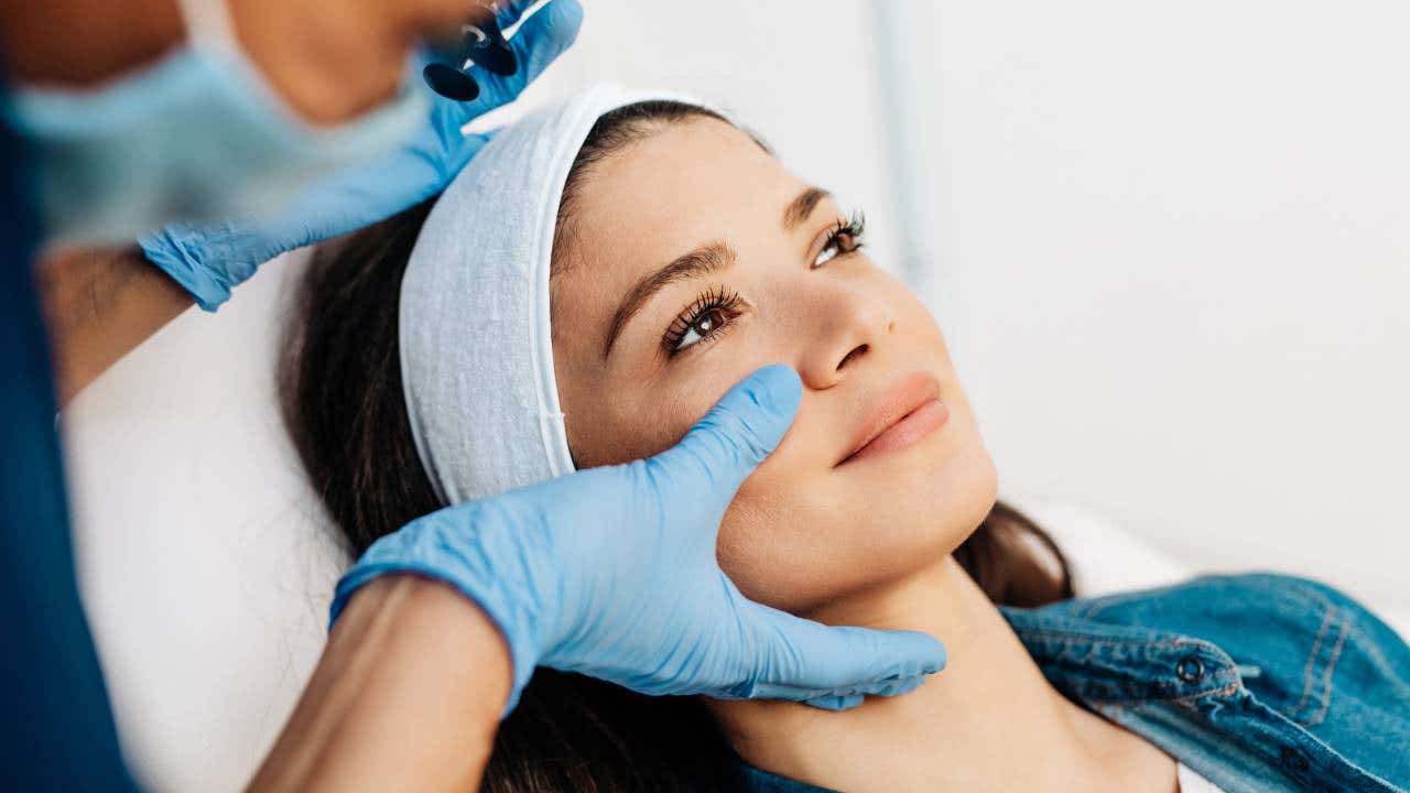 Young woman getting a rejuvenating facial injections at beauty clinic
