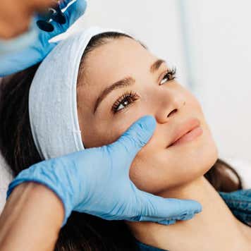 Young woman getting a rejuvenating facial injections at beauty clinic