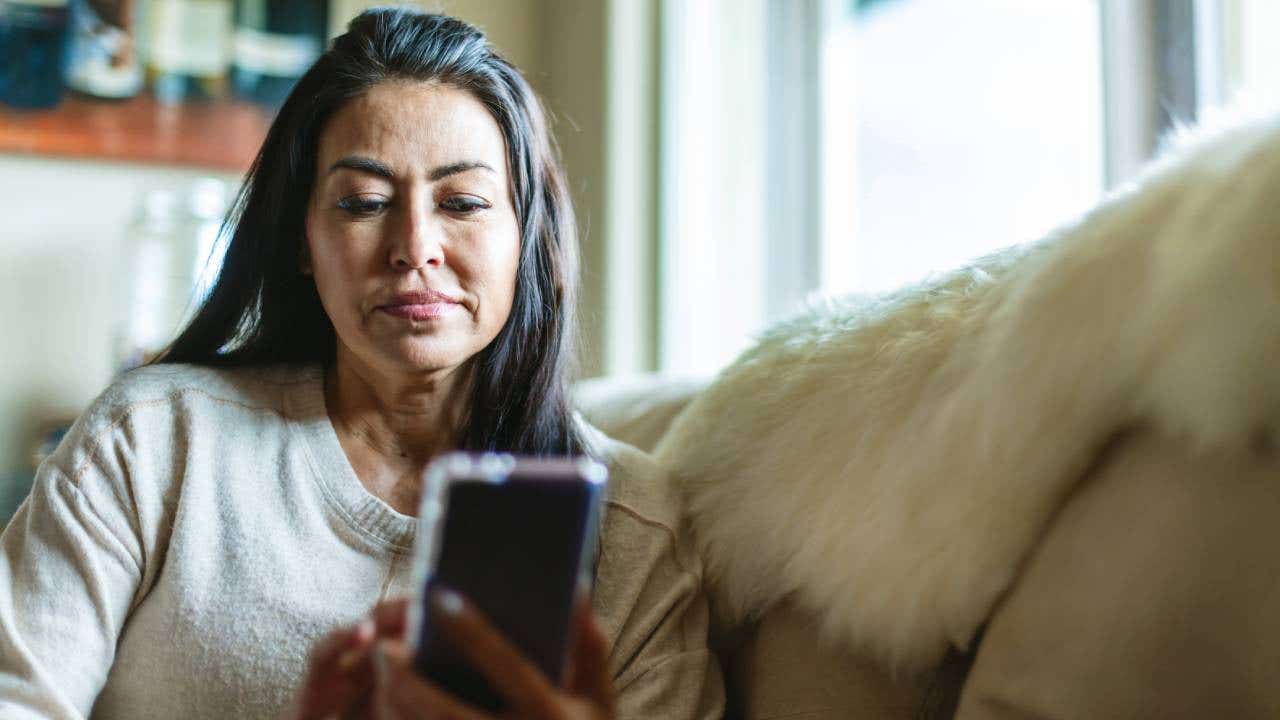 Mature Adult Female of Hispanic Ethnicity Using Smart Phone In the Home Photo Series