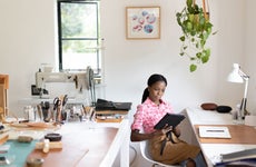 Female, Black small business owner working in her leatherwork studio