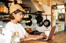 Restaurant owner making purchases on laptop