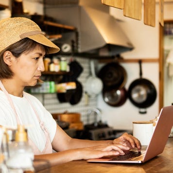 Restaurant owner making purchases on laptop