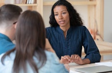 Biracial female consultant have meeting with couple clients