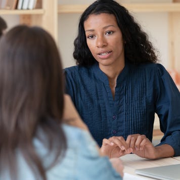 Biracial female consultant have meeting with couple clients