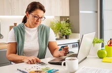 Concentrated woman calculating home expenses