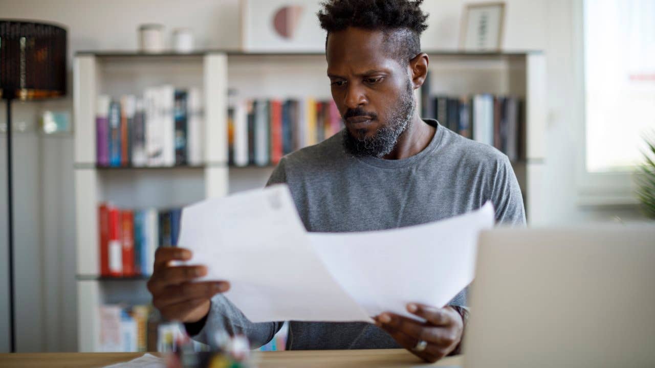 Man looking over paperwork at home